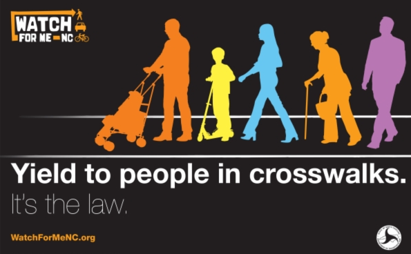 Poster with illustrations of pedestrians says Watch For Me, Yield To people in crosswalks, It's the law