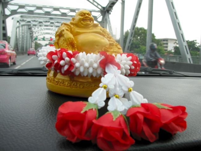 Small statue on the dashboard of a Bangkok taxi